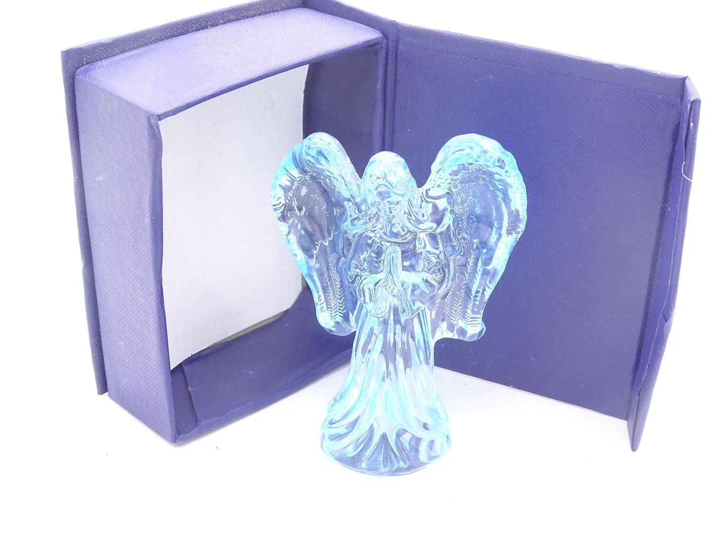 Praying angel made of blue crystal glass